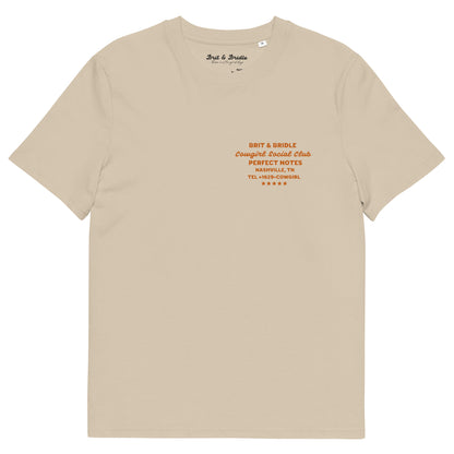 A beige short-sleeve t-shirt with orange printed text on the left chest reading 'BRIT & BRIDLE Congregated Social Club PERFECT NOTES NASHVILLE, TN TEL:940-2692' and a small 'Brit & Bridle' neck label, shown on a plain white background.
