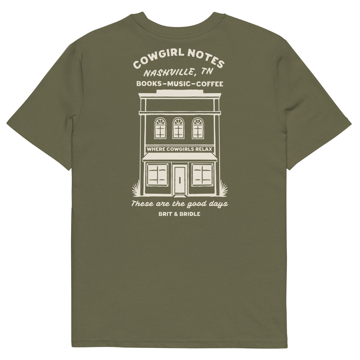 An olive green short-sleeve t-shirt shown from the back, featuring a white graphic print of a building with the text 'COWGIRL NOTES NASHVILLE, TN BOOKS - MUSIC - COFFEE' and 'BRIT & BRIDLE' printed below.