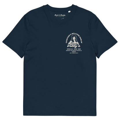 A short-sleeve crewneck t-shirt with a vintage-style white graphic on the left chest. The graphic features a stylized portrait of Dolly Parton with the text 'Everyone's Welcome at Dolly's' and 'Dolly's Open 9-5 Mon-Sun'.