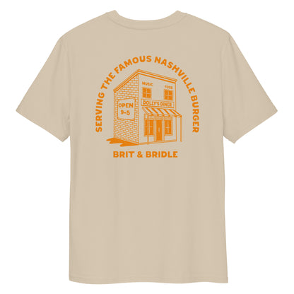 A beige short-sleeve t-shirt shown from the back, featuring a prominent orange graphic print of a diner building with the text 'SERVING THE FAMOUS NASHVILLE BUNGER' and 'BRIT & BRIDLE'.