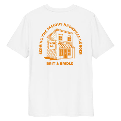 A white short-sleeve t-shirt with a large orange graphic print on the back. The graphic features an illustration of a diner building with the text 'SERVING THE FAMOUS NASHVILLE BUNGER' arched above it and 'BRIT & BRIDLE' printed below.