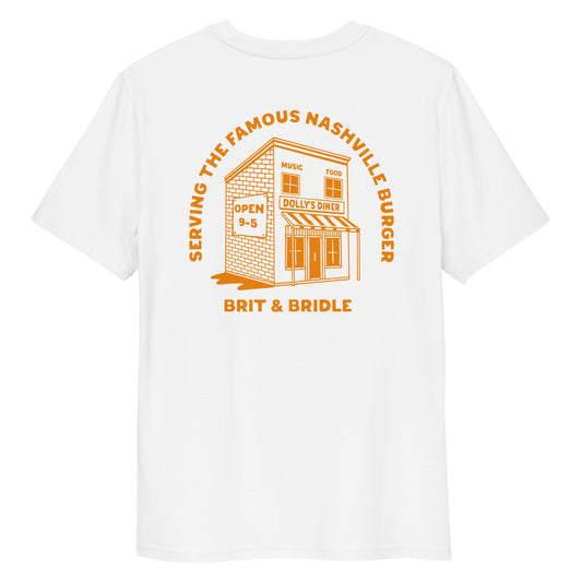 A white short-sleeve t-shirt with a large orange graphic print on the back. The graphic features an illustration of a diner building with the text 'SERVING THE FAMOUS NASHVILLE BUNGER' arched above it and 'BRIT & BRIDLE' printed below.