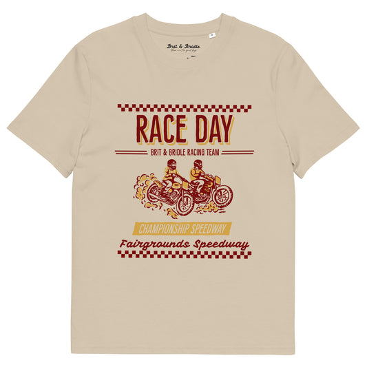 A beige crewneck t-shirt featuring a vintage-style racing graphic on the front with the text 'RACE DAY', 'BRIT & BRIDLE RACING TEAM', and 'Fairgrounds Speedway' in red and yellow.